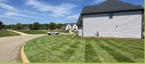 Large corner lawn with fresh mowing stripes